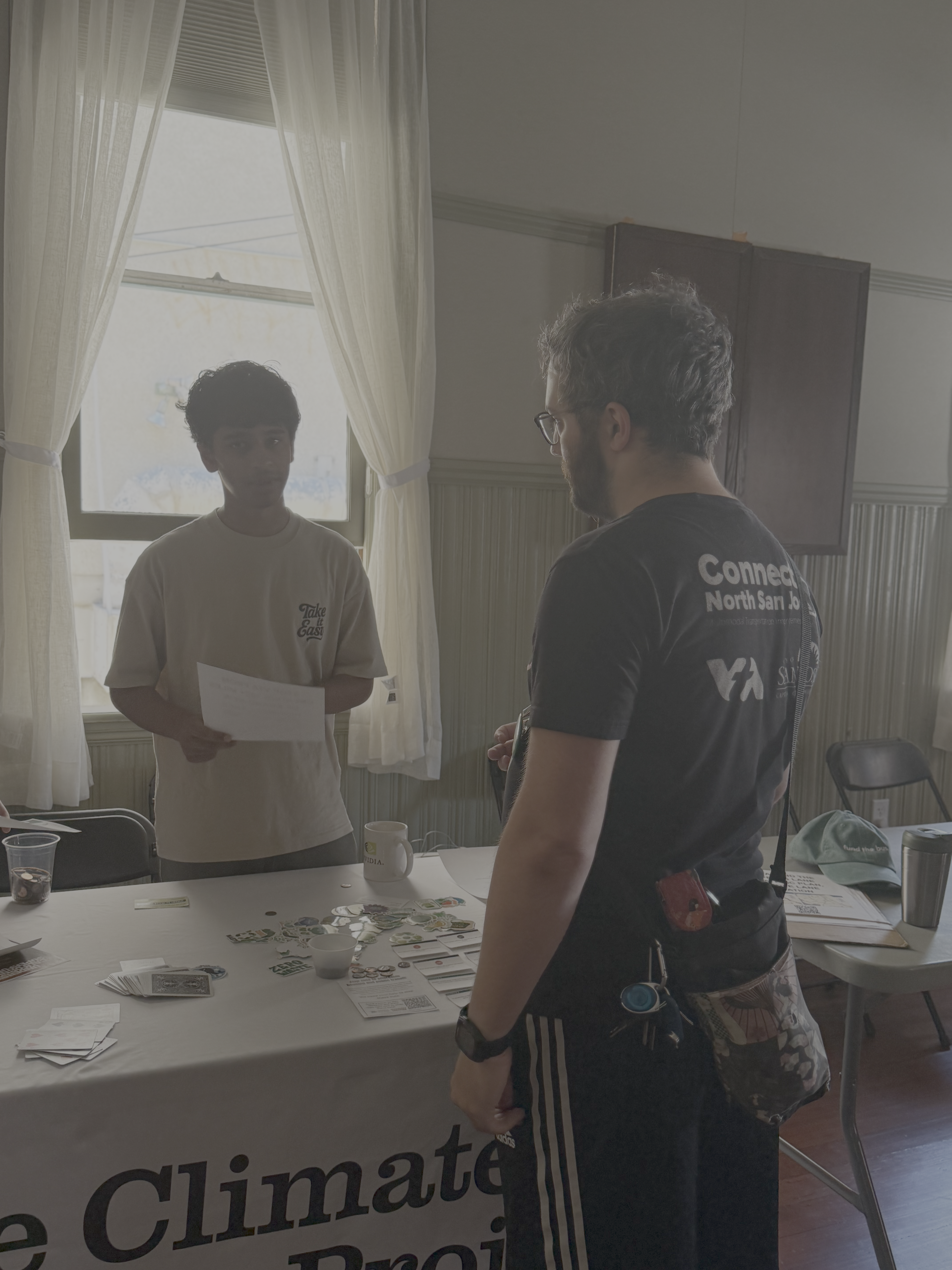 An IRISTEM student discussing community climate work with a local advocate