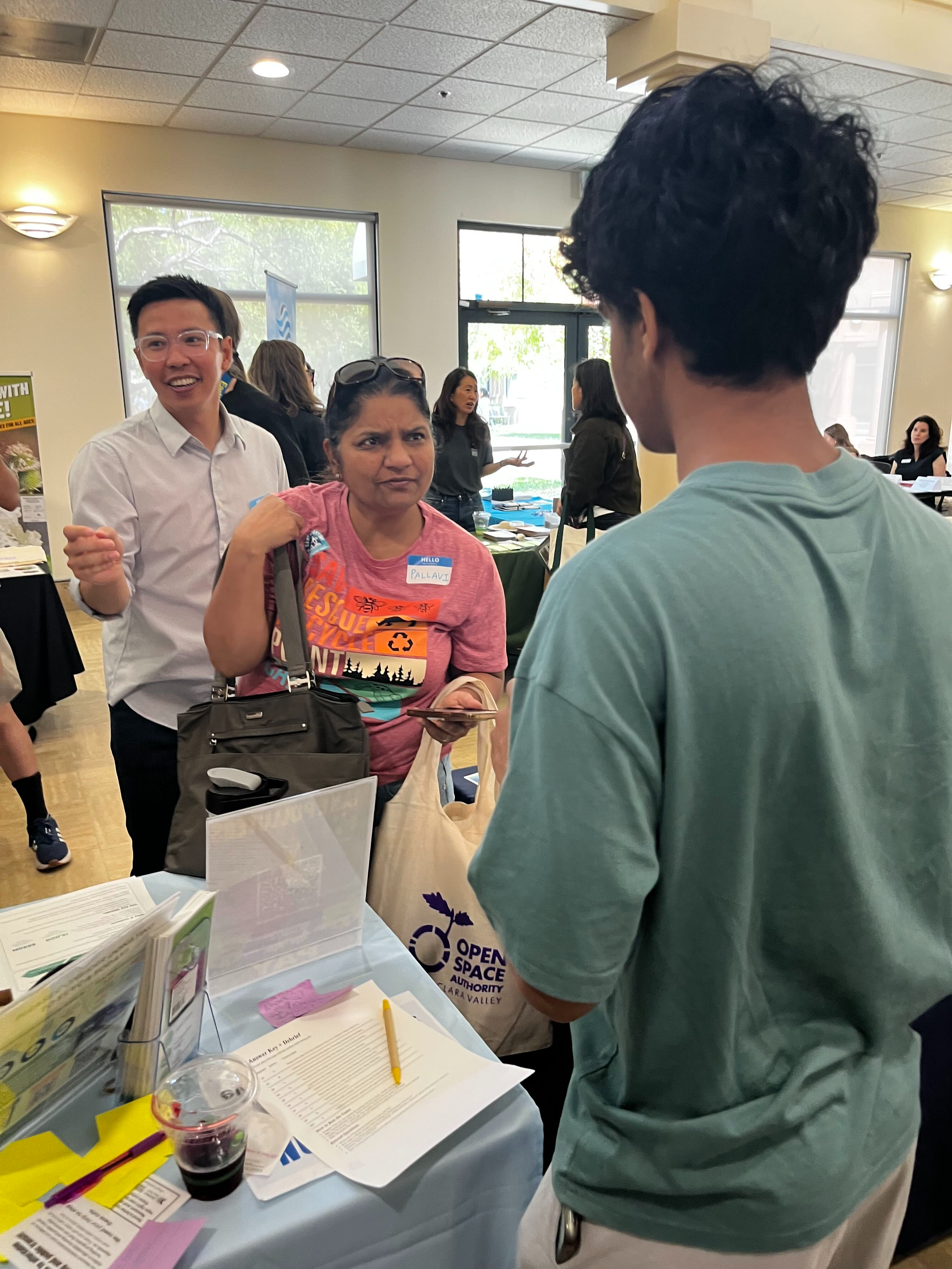 An IRISTEM student discussing climate education with visitors at a Silicon Valley Youth Climate Action event